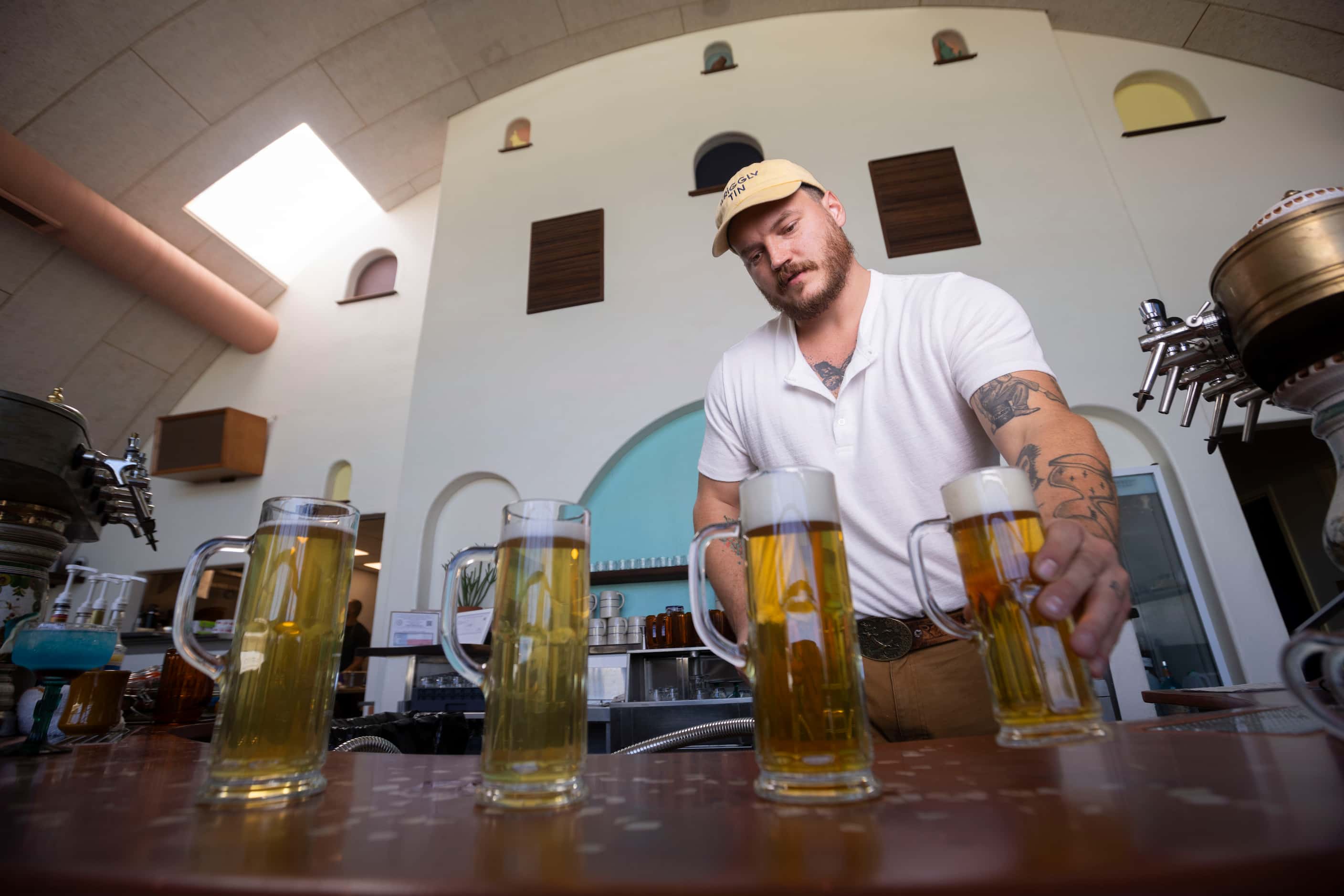 Owner and CEO Jacob Boger places the Ojo Moro beer at the bar in the Wriggly Tin, a new bar...