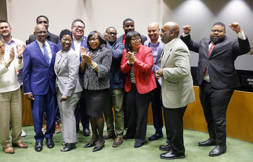 Dallas Black Chamber of Commerce Harrison L. Blair (right) flexes as City Manager T.C....