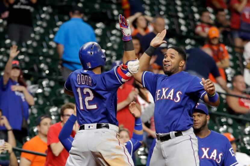 Texas Rangers' Rougned Odor (12) celebrates with Elvis Andrus, right, after hitting a home...