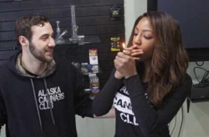  Peter Lomonaco, co-founder of the Alaska Cannabis Club, and CEO Charlo Greene share a joint...