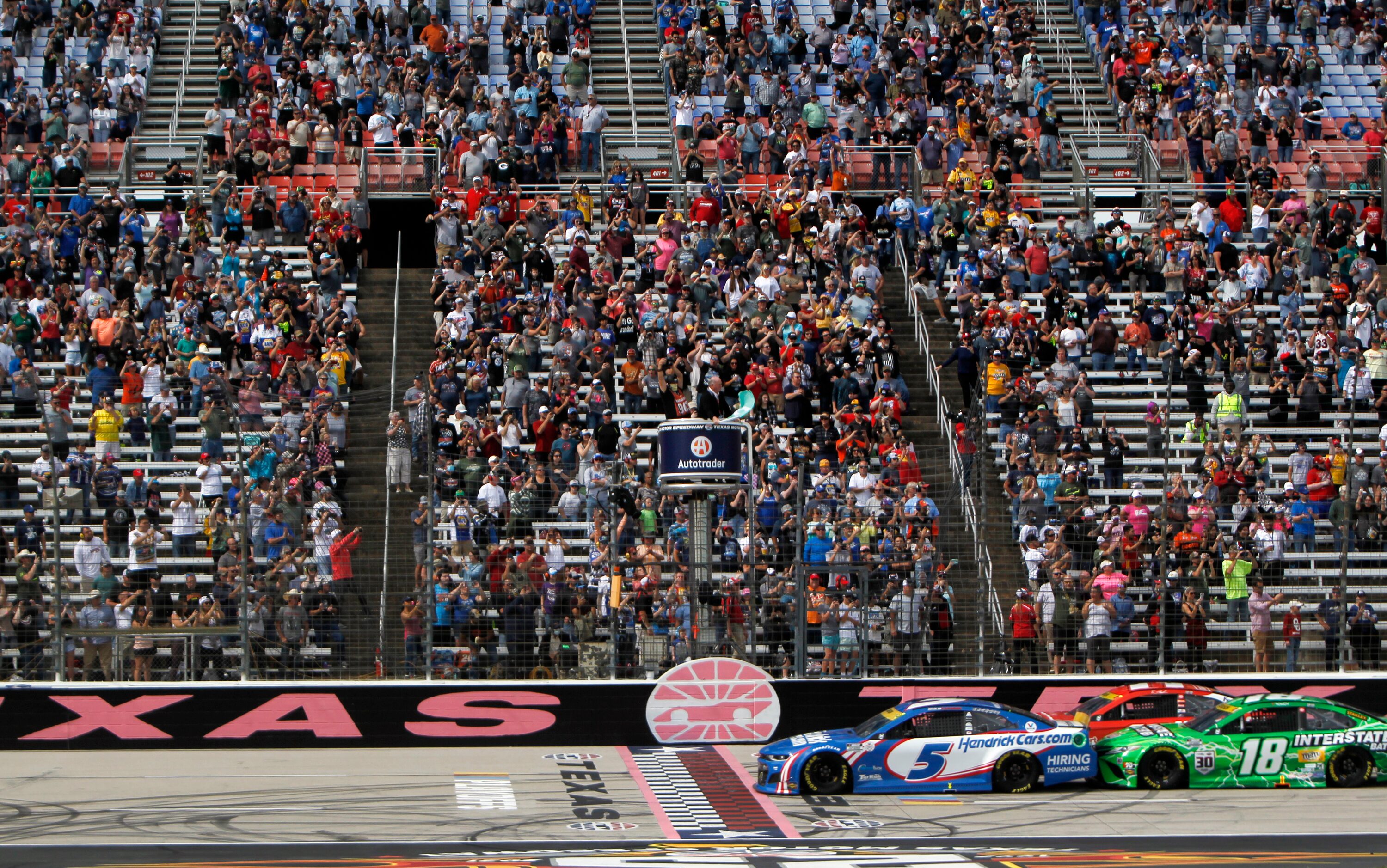 Driver Kyle Larson responds to the green flag in the pole position to start the race in his...