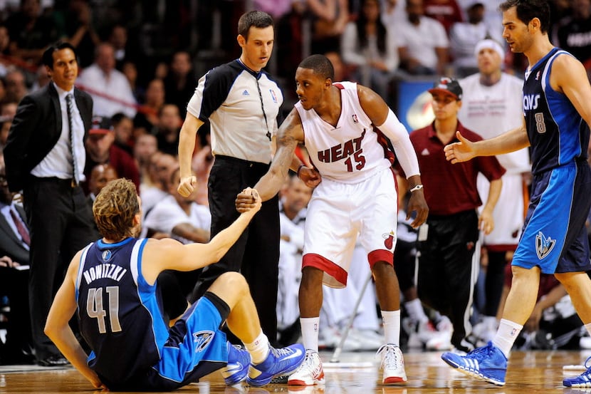 Nov 15, 2013; Miami, FL, USA; Miami Heat point guard Mario Chalmers (15) helps up Dallas...