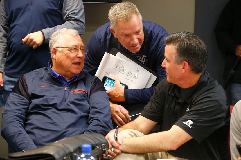 Allen's Steve Williams (from left) talks with head football coach Terry Gambill with Plano's...
