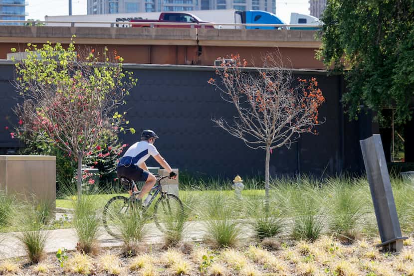 A cyclist rides along the Hi Line Connector trail in Dallas' Design District June 26.