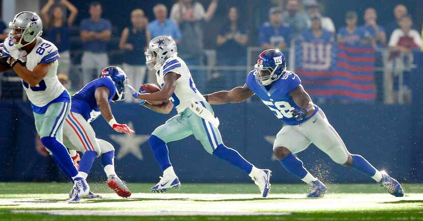 Dallas Cowboys running back Lance Dunbar (25) cuts back across the field as he tries to find...