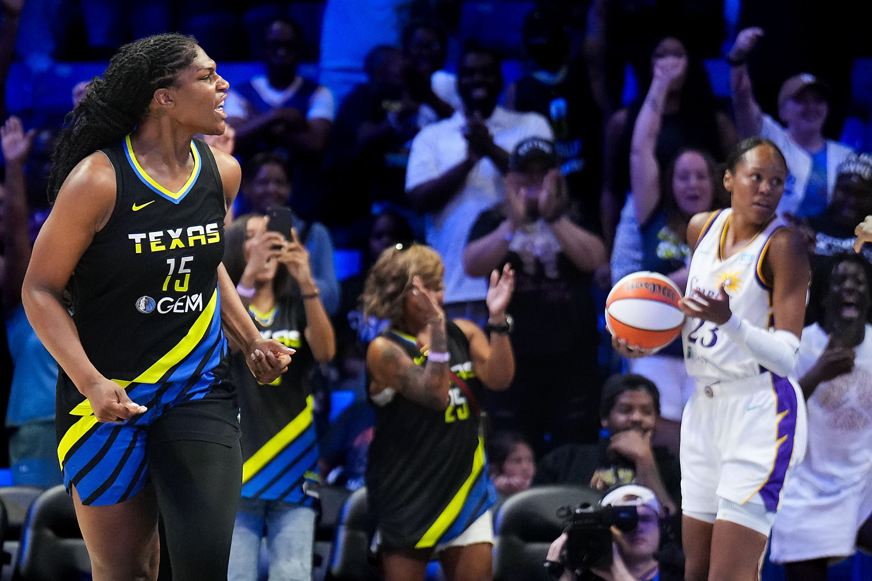 Dallas Wings center Teaira McCowan (15) celebrates after scoring to to give the Wings a...