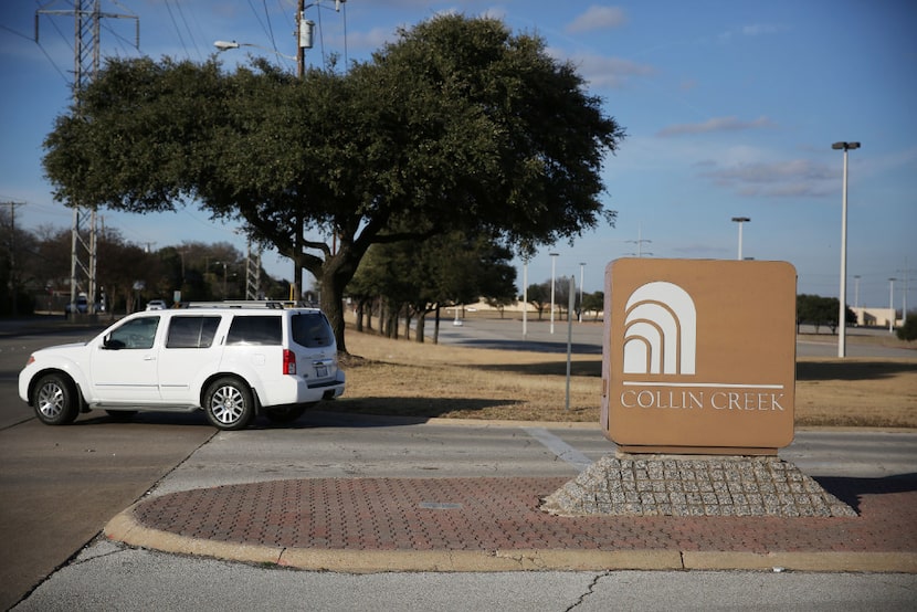 A vehicle exits the parking lot at Collin Creek Mall in Plano. Redevelopment options are...