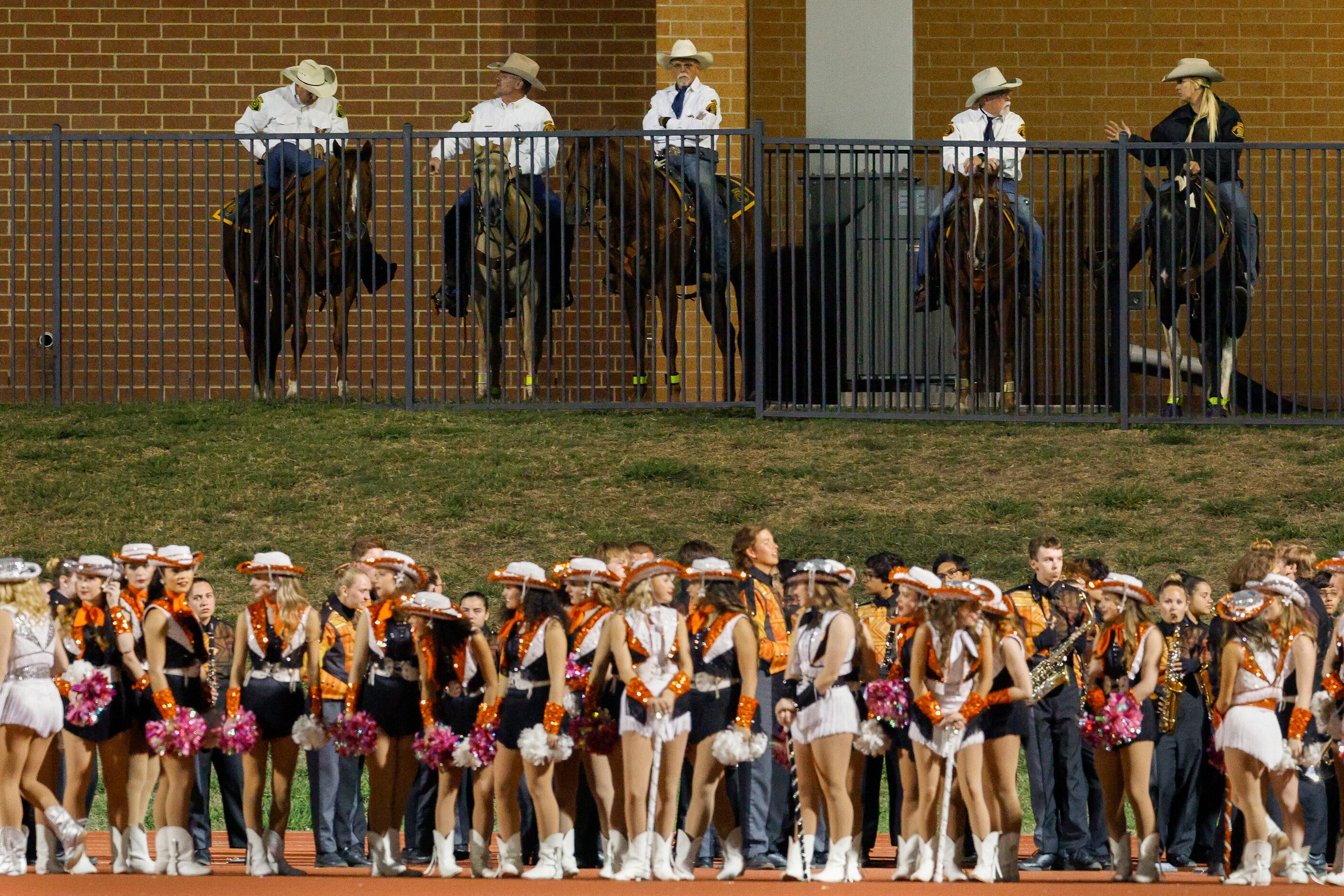 Rockwall County Sheriff’s deputies watch the first half of a District 10-6A game between...