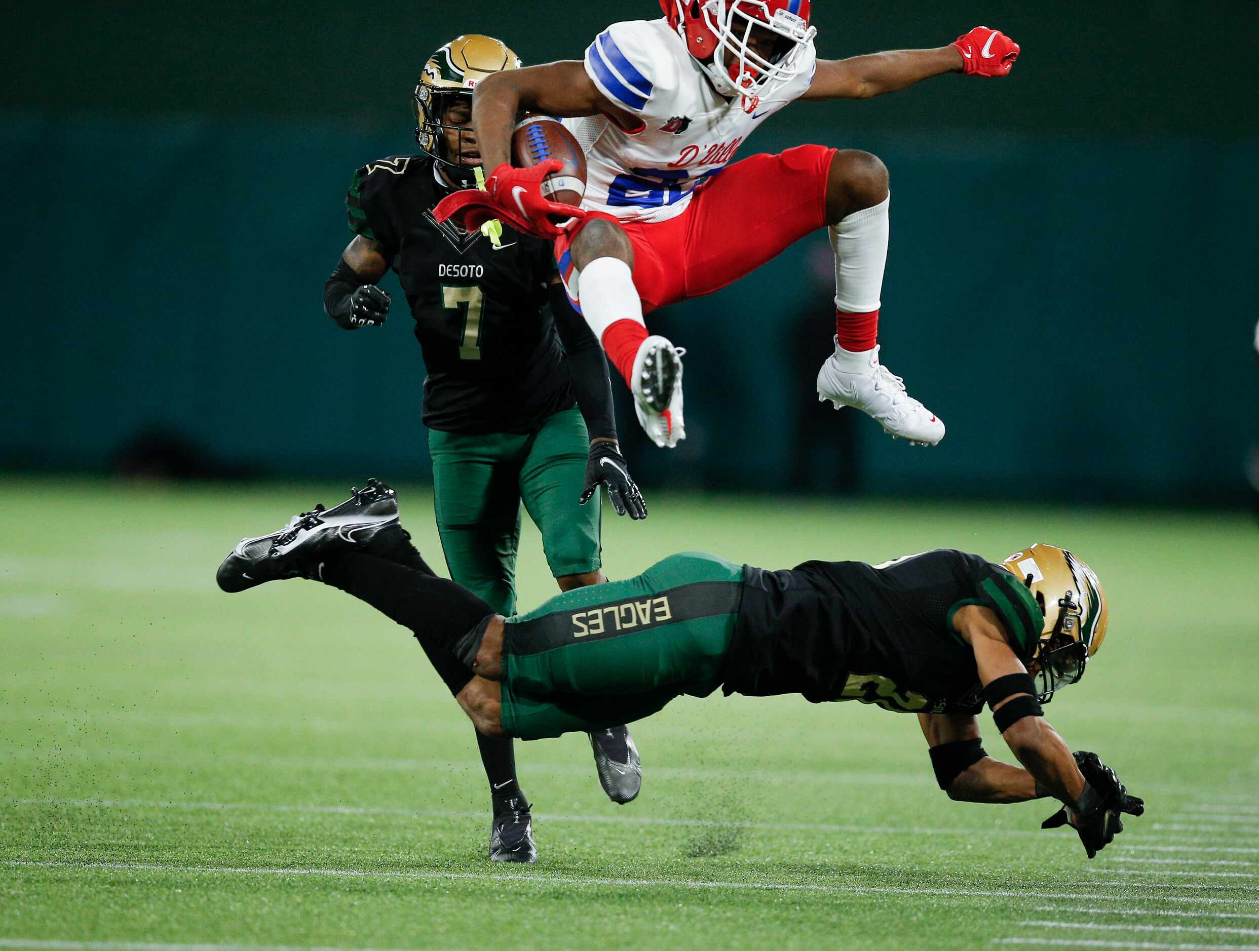 Duncanville sophomore wide receiver Lontrell Turner (22) leaps over DeSoto sophomore safety...