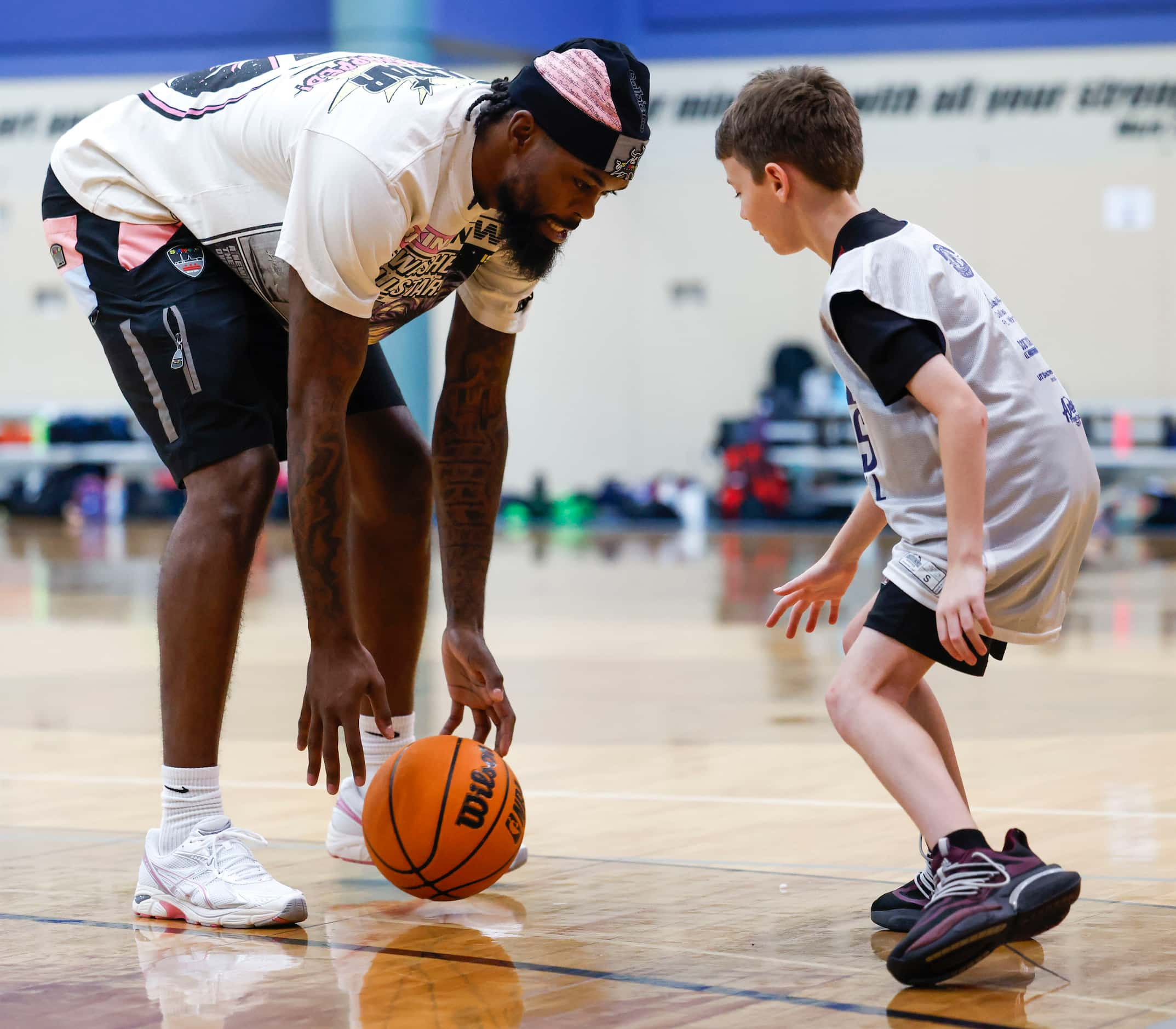 Dallas Mavericks’ Naji Marshall, play ball with young basketball campers during a Hoop Camp,...