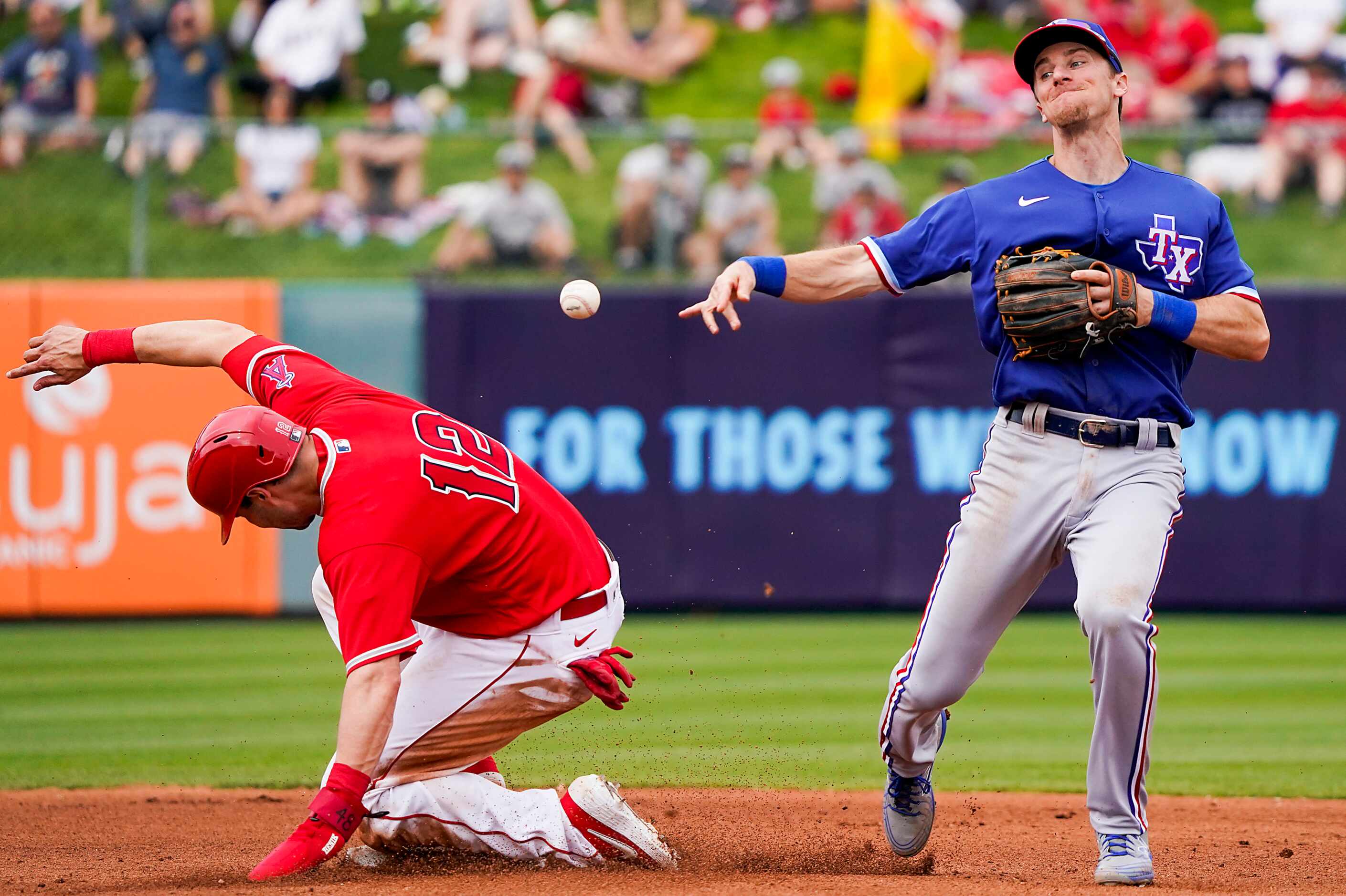 Texas Rangers shortstop Matt Duffy makes the relay over Los Angeles Angels catcher Anthony...