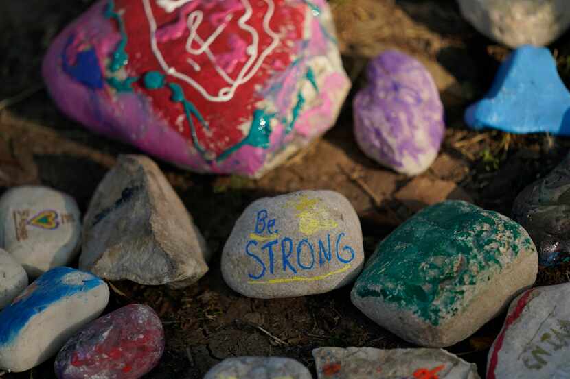 Decorated stones formed a make-shift memorial to honor the victims of the school shootings...