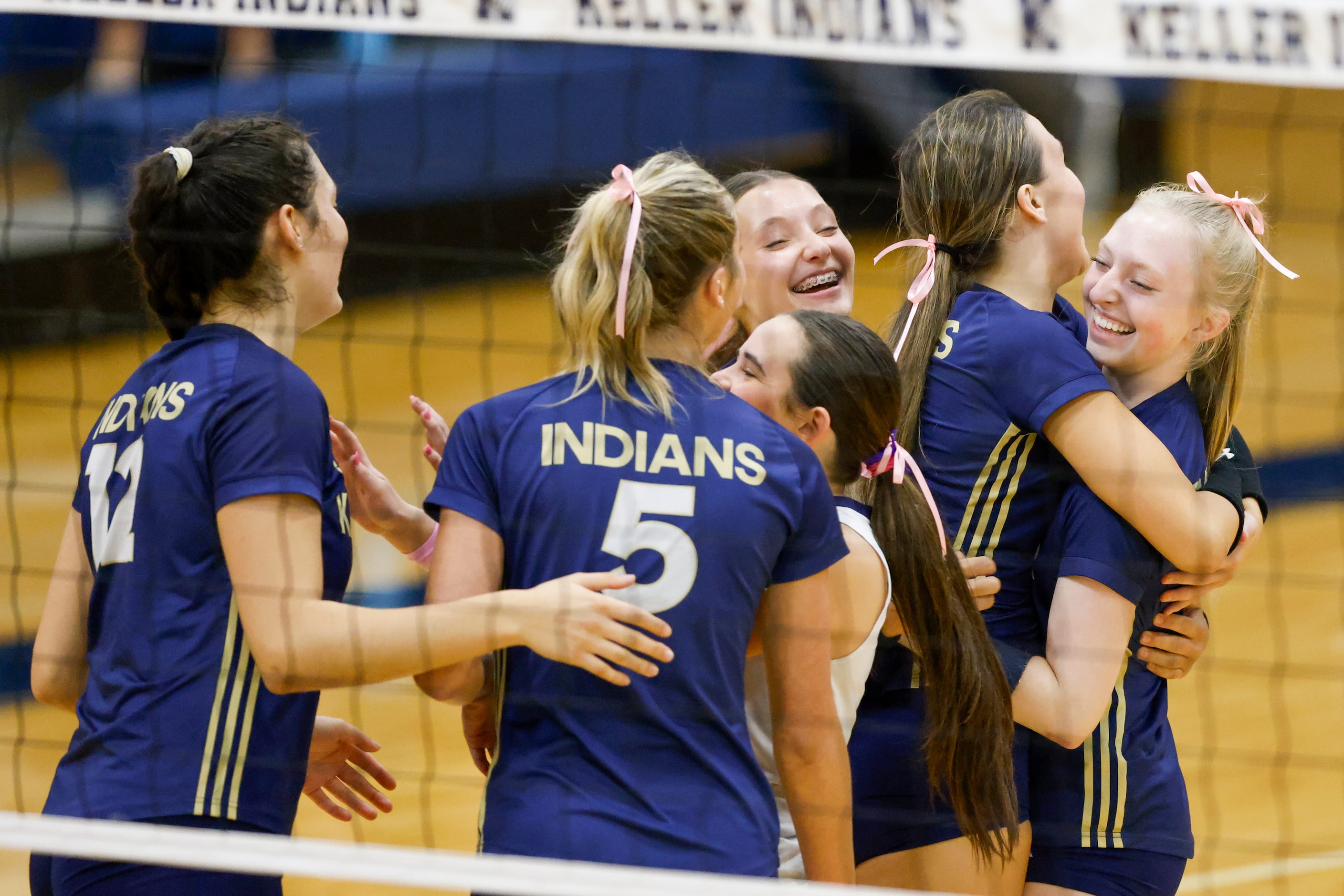 Keller players celebrate after a point during a high school volleyball match against Justin...