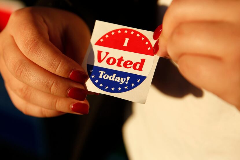 Maria Garcia, a first-time voter, holds an "I Voted Today!" sticker after casting her ballot...