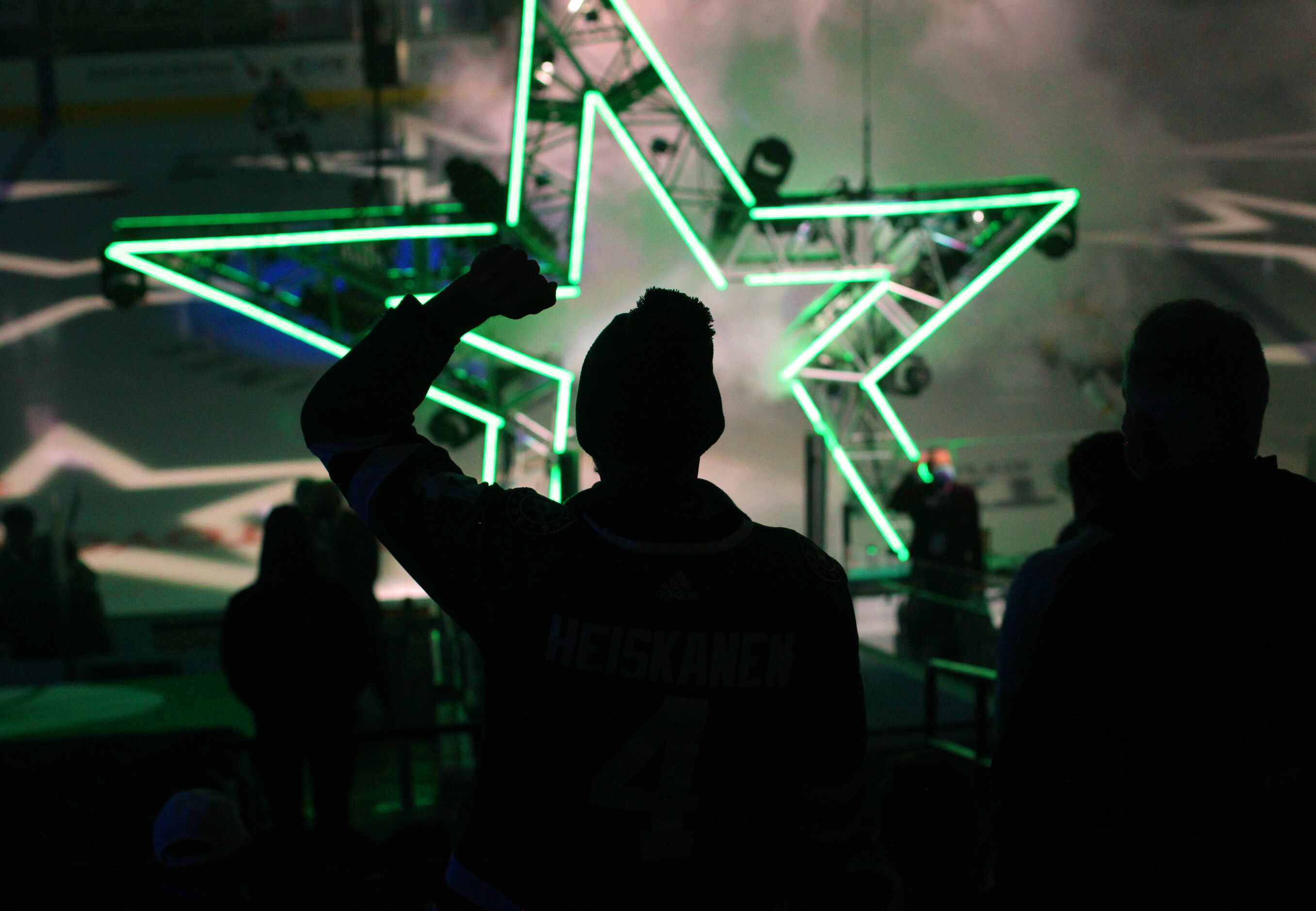 A Dallas Stars fan pumps his fist in the air as the Stars take to the ice just prior to the...