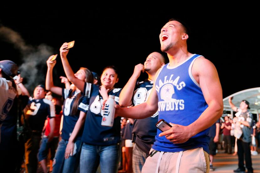 Tomas Acosta, right, from Dallas, reacts to Dallas Cowboys' picking Byron Jones for the NFL...