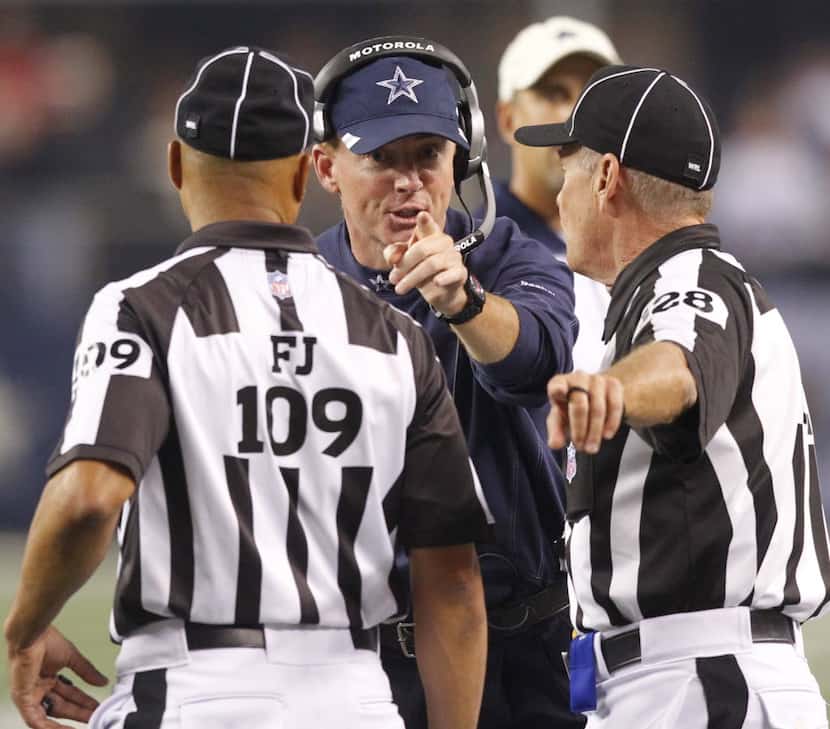 Head coach jason Garrett talks with officials after a pass interference call during the...
