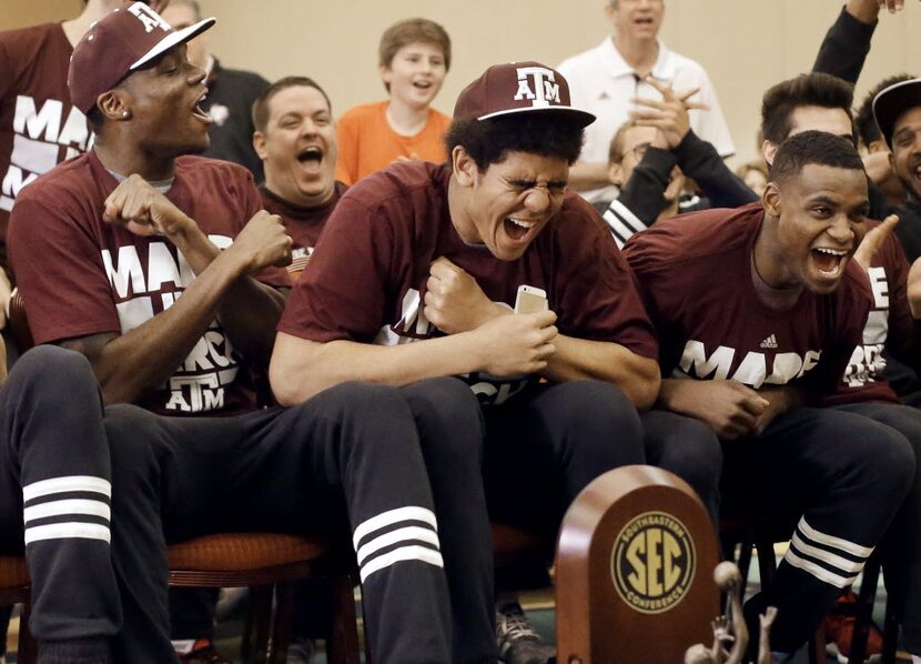 Texas A&M's Tyler Davis, center, cheers as his team's selection is announced in the NCAA...