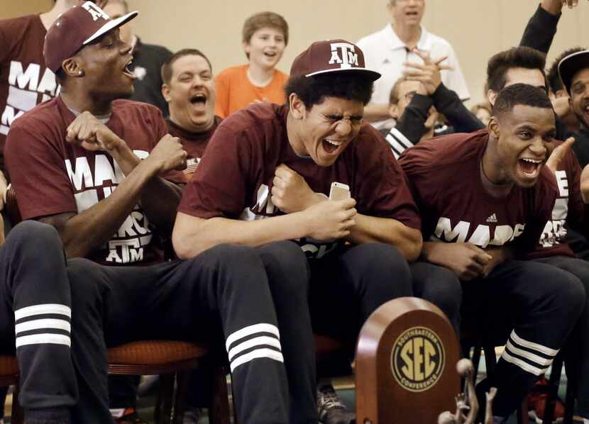 Texas A&M's Tyler Davis, center, cheers as his team's selection is announced in the NCAA...