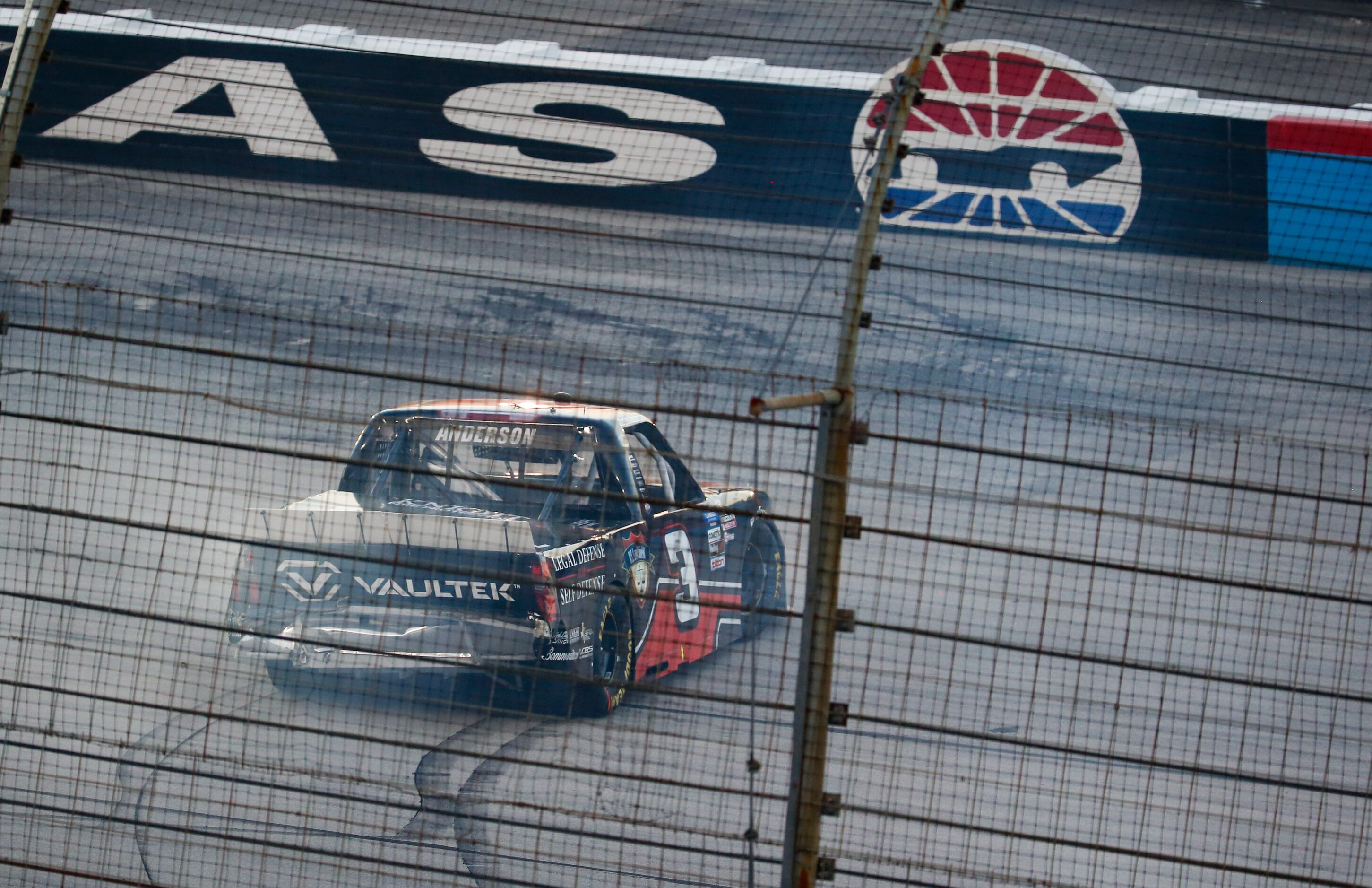 Jordan Anderson (No. 3) stops after crashing during the NASCAR VANKOR 350 truck series race...