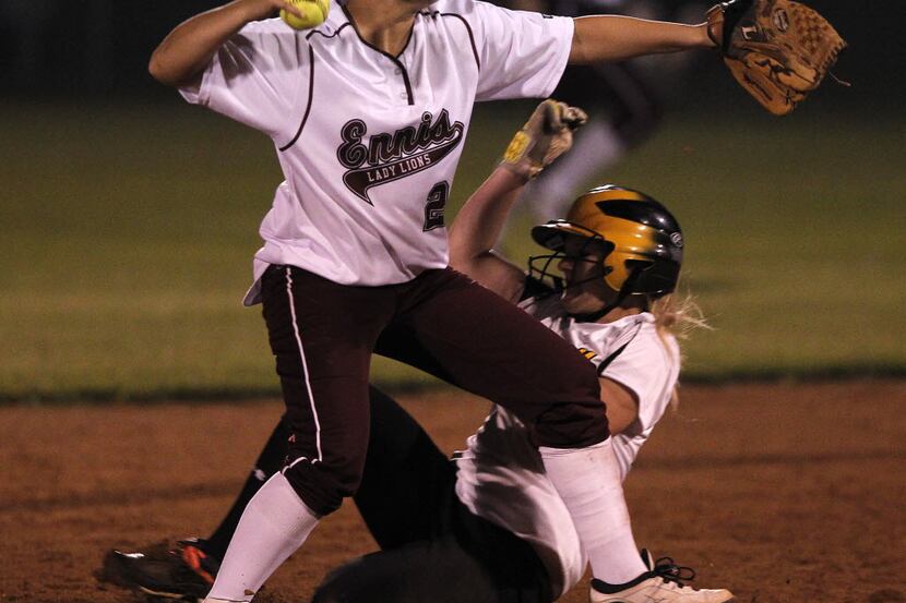 Ennis' Courtlyn Benitez (2) turns a double play against Forney Alex Kovacs (5) in girls high...