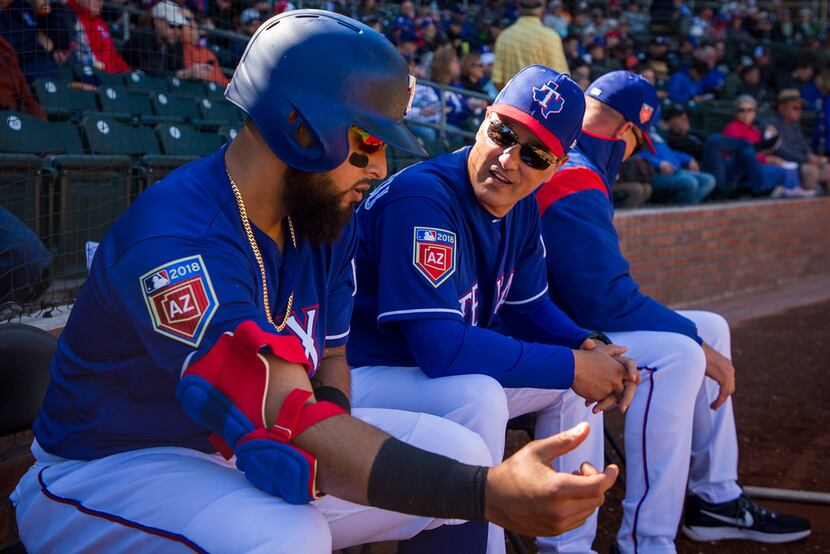 FILE - Rangers second baseman Rougned Odor talks with bench coach Don Wakamatsu before...