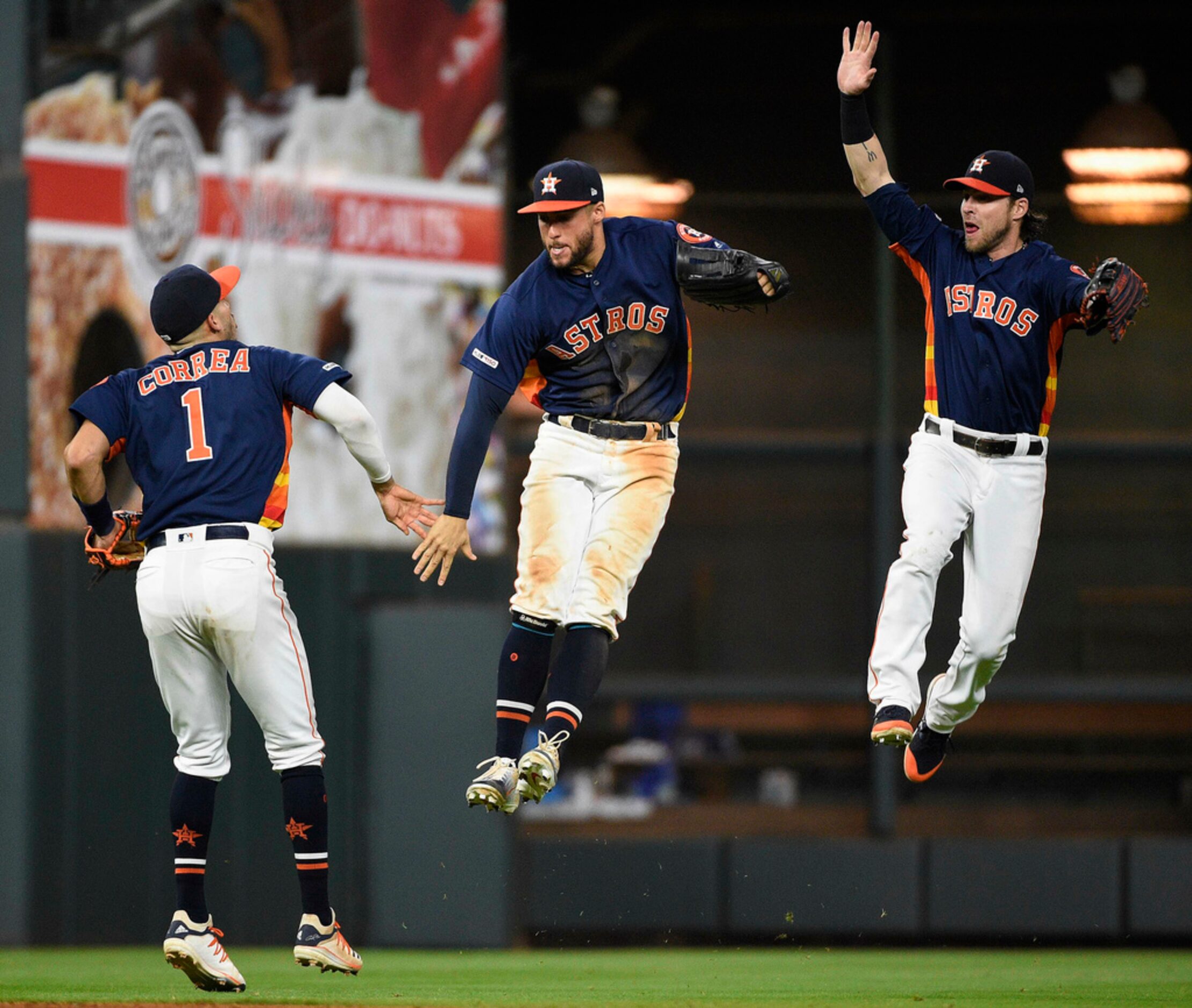 Houston Astros' Carlos Correa (1), George Springer, center, and Josh Reddick celebrates the...