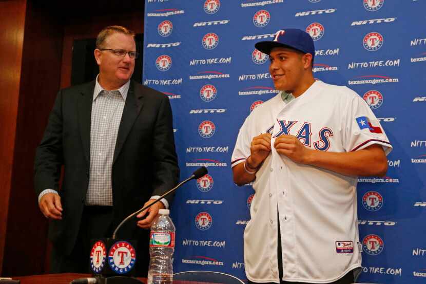 Kip Fagg, left, of the Texas Rangers introduces first round draft pick Luis Ortiz, at Globe...