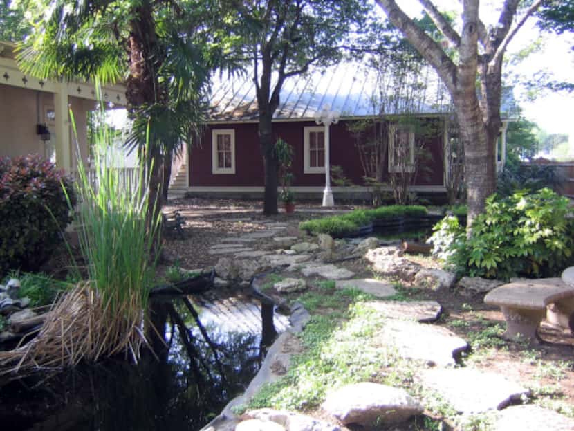 A pond and trees, plus a pool are part of the courtyard at Ye Kendall Inn, Boerne.