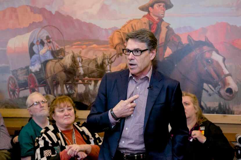 
Former Texas Gov. Rick Perry talks to voters during a meet-and-greet campaign event at...