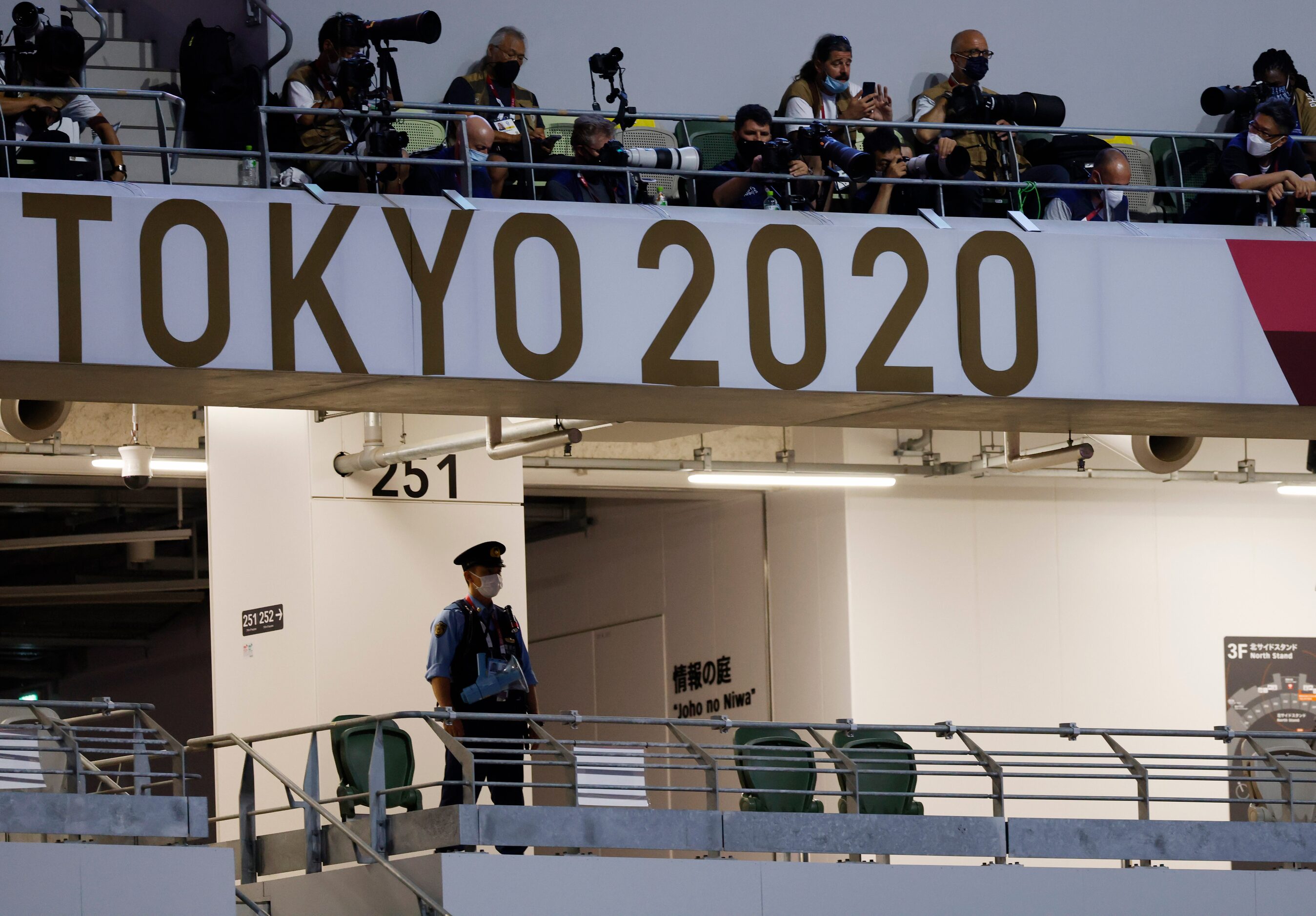 Police keep watch prior to the start of the opening ceremony for the postponed 2020 Tokyo...