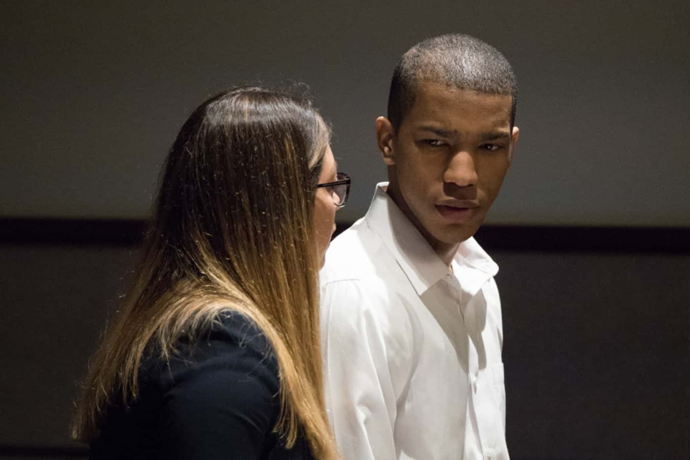 Defense attorney Camila Francino and defendant Eric Johnson talk Wednesday during a recess...
