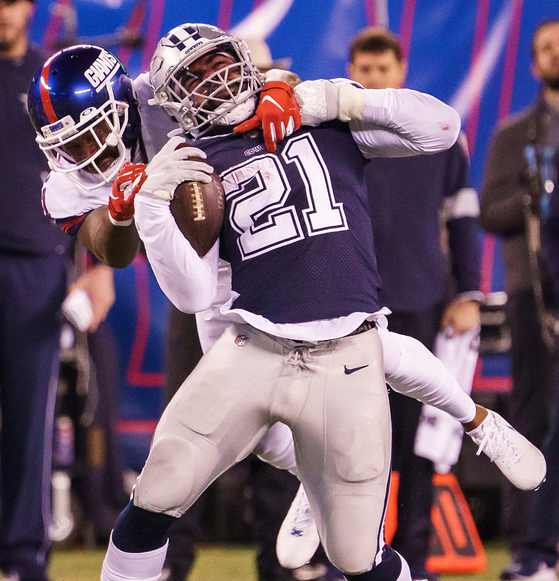 Dallas Cowboys running back Ezekiel Elliott (21) is brought down by New York Giants free...