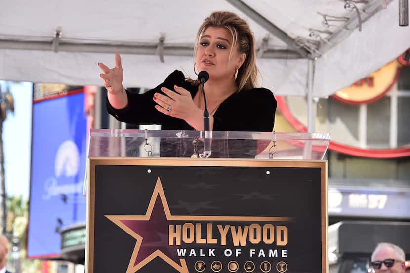 Singer and talk show host Kelly Clarkson speaks during a ceremony honoring her with a new...