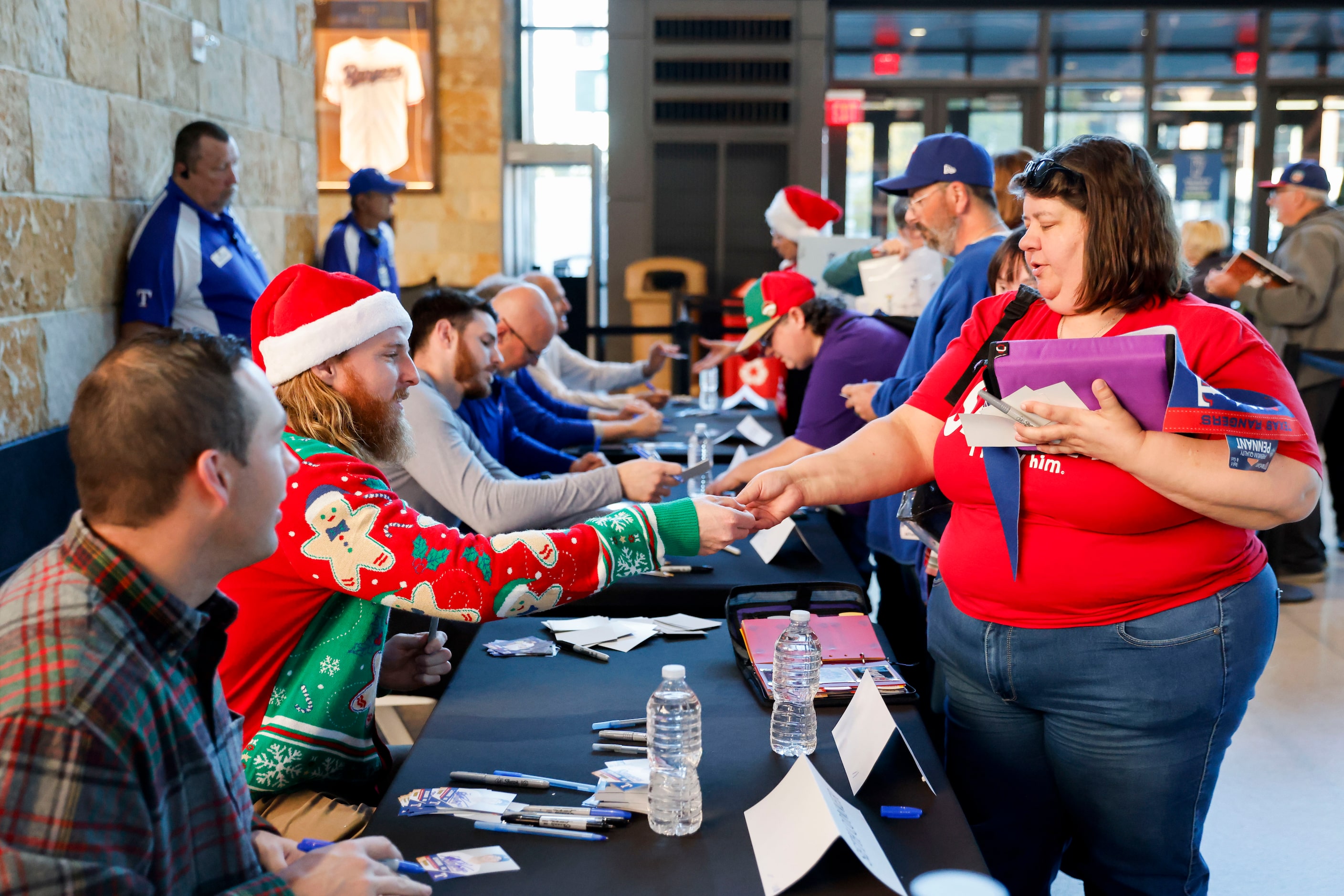 Texas Rangers pitcher Jon Gray (center) interacts with the crowd as they give autographs...