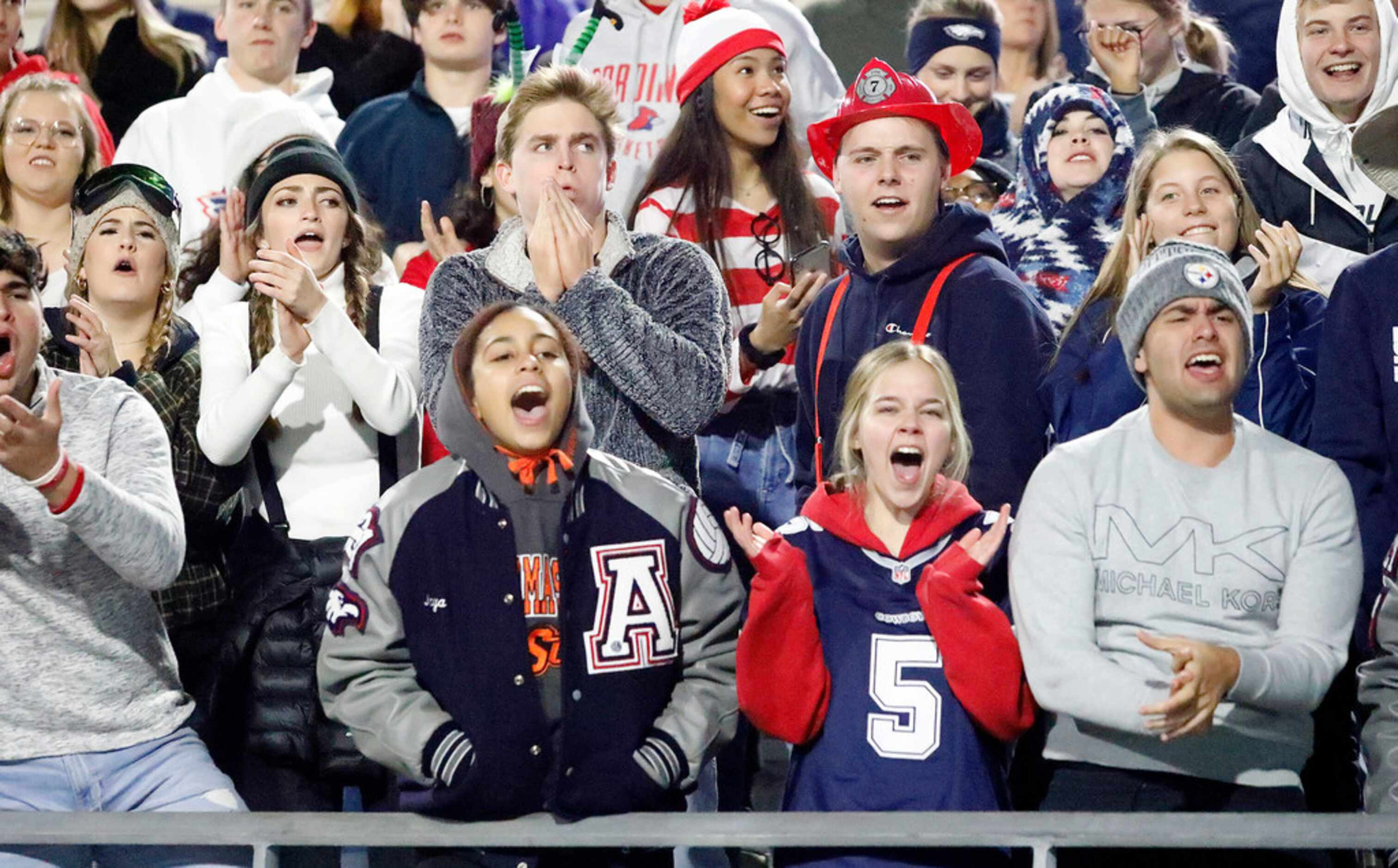 The Allen High School student section celebrates a touchdown during the first half as...