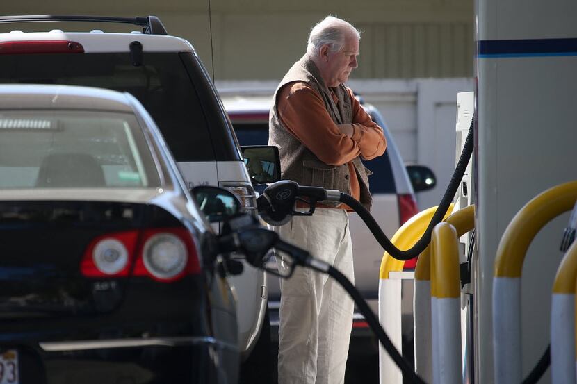 MILL VALLEY, CA - MARCH 03:  A customer pumps gasoline into his car at an Arco gas station...