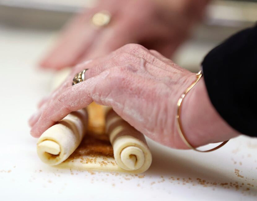 Gently roll up each of the sides of the puff pastry in order to make palmiers 