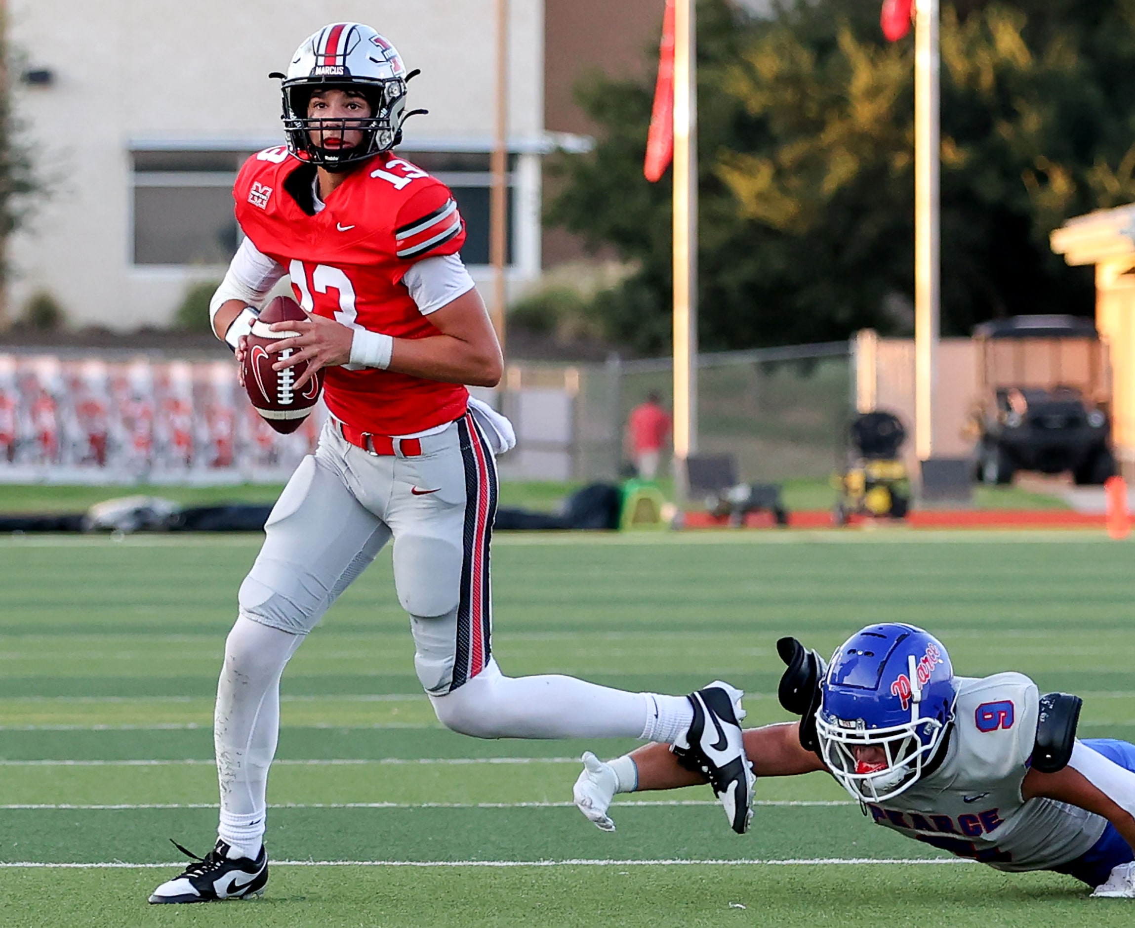 Flower Mound Marcus quarterback Colton Nussmeier (13) gets past Richardson Pearce defensive...