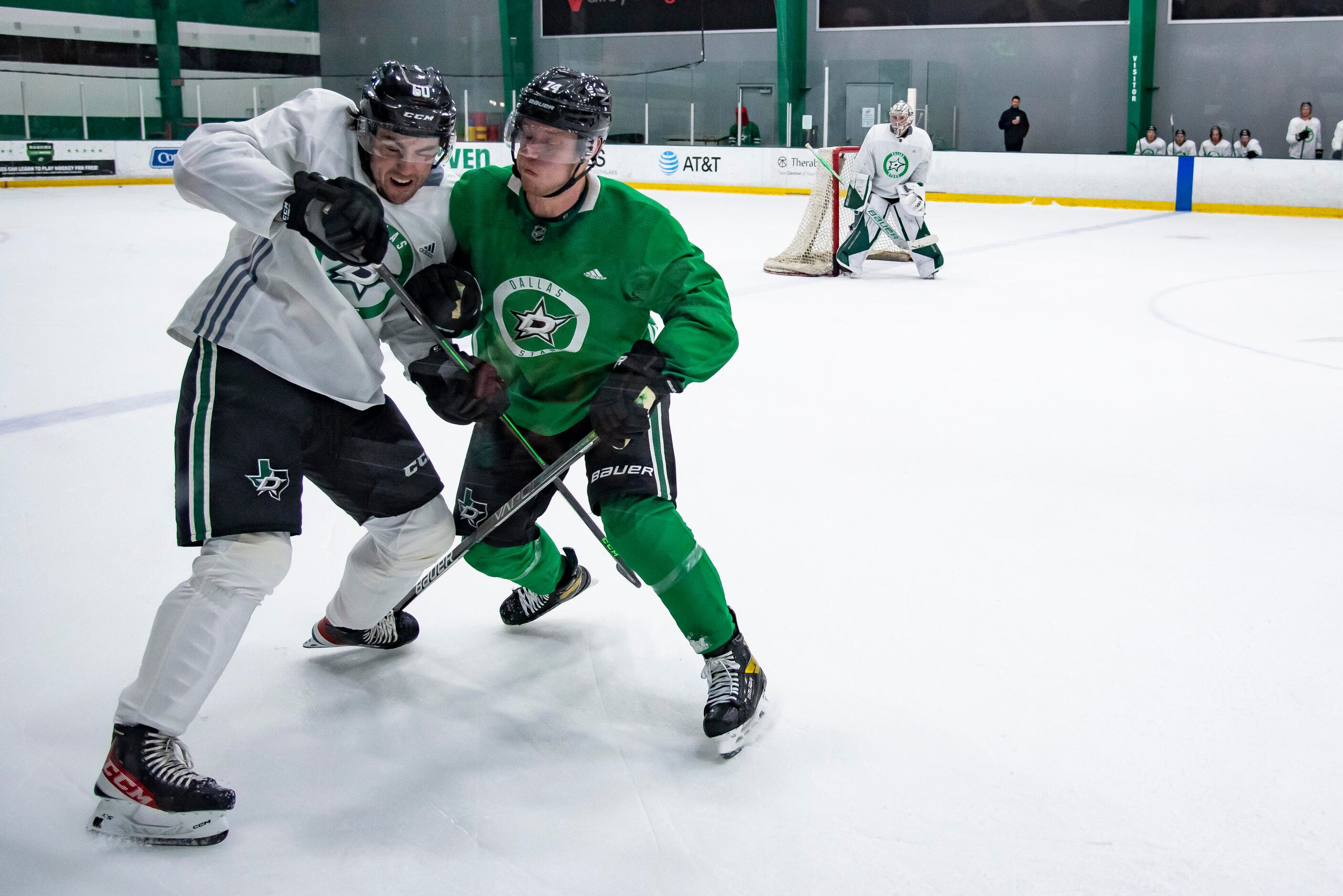 From left, defenseman Jacob Holmes (60) and forward Ryan Sandelin (74) crash into one...