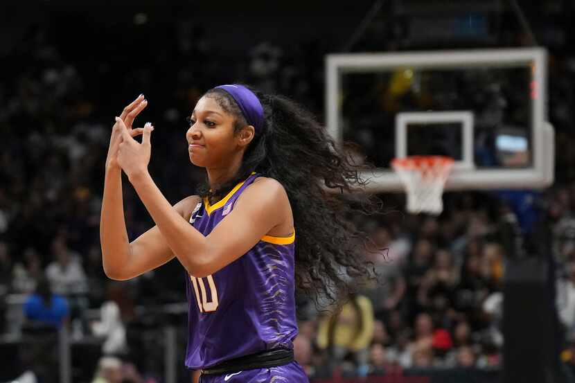 LSU forward Angel Reese points to her ring finger during the second half of the NCAA Women's...