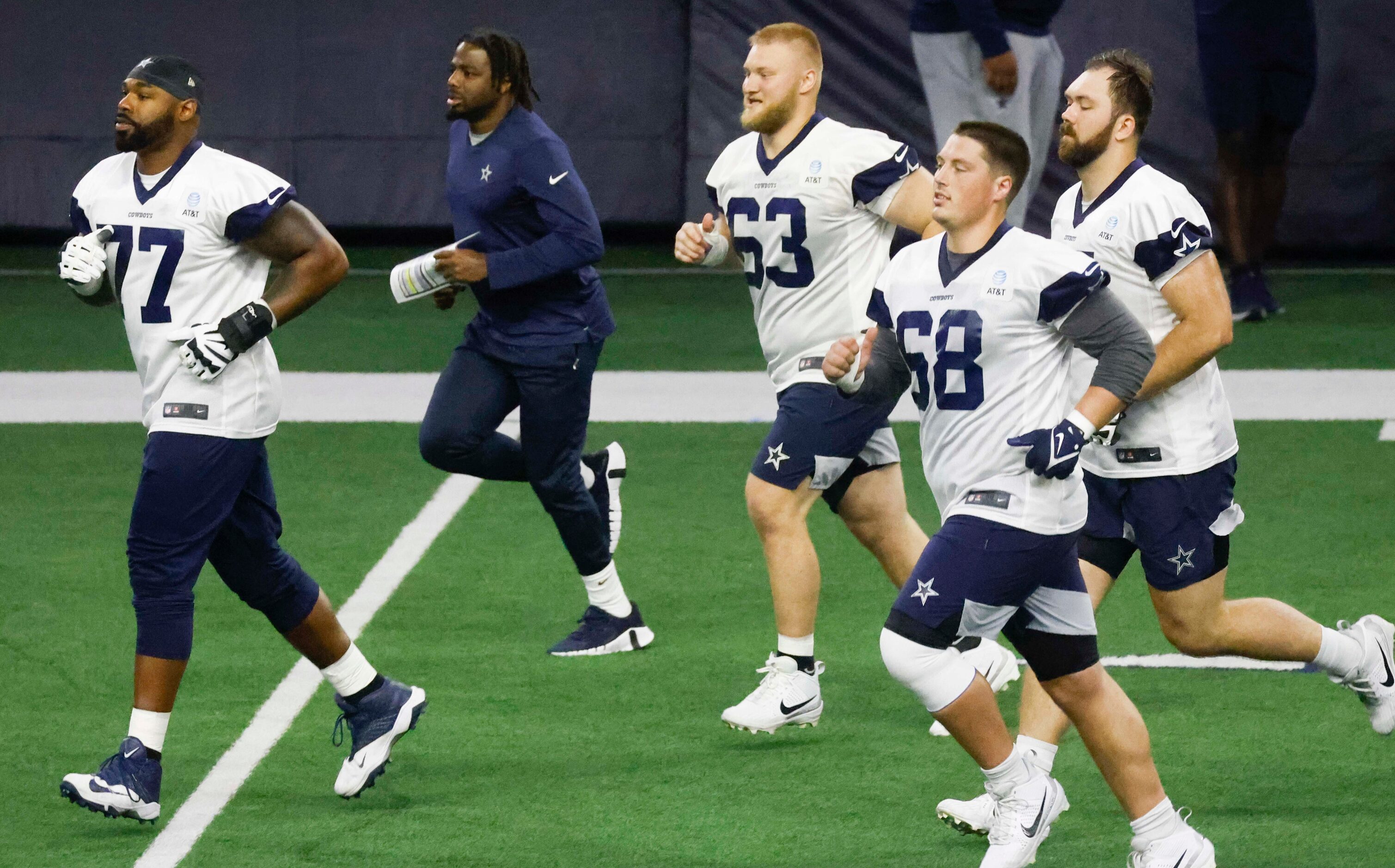 Dallas Cowboys offensive tackle Tyron Smith (77), center Tyler Biadasz (63), guard Matt...