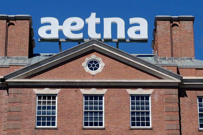 An Aetna Inc. sign sits atop a building at the company headquarters in Hartford, Conn. 