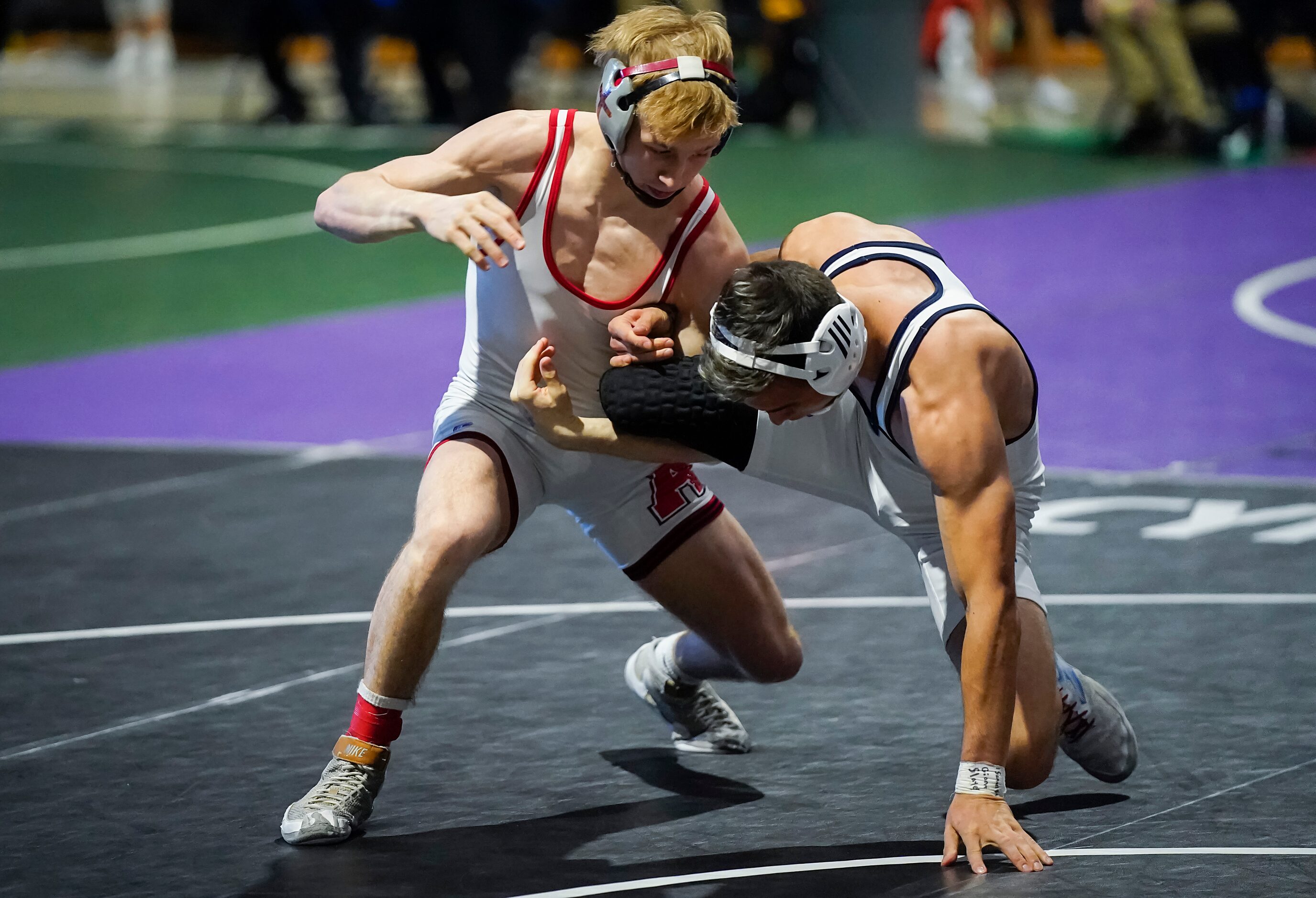 Braxton Brown of Allen (left) wrestles Micah White of Humble Kingwood for the 6A boys...