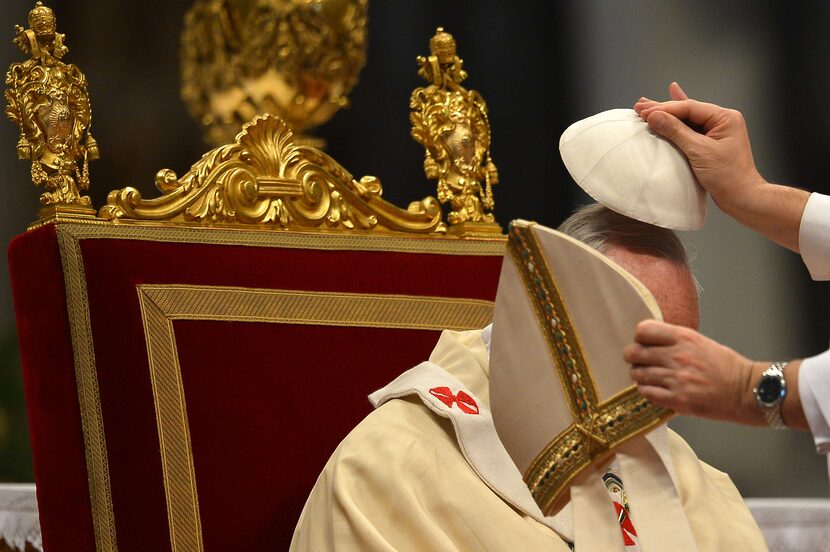  Pope Francis is helped to put his mitre on during the Epiphany mass in St. Peter's...