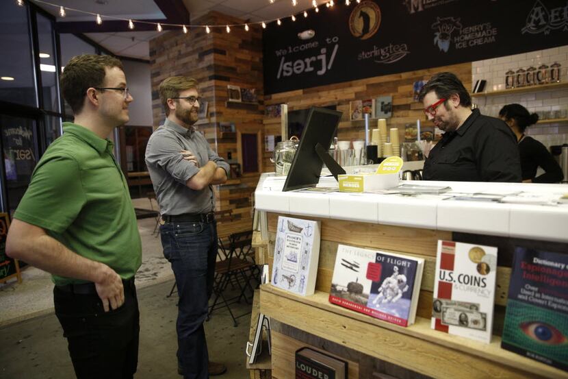 Owner John Walsh (far right) takes coffee orders from Matthew Rodgers (far left) and Ross...