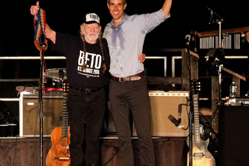 Senate candidate Beto O'Rourke stands on stage with Willie Nelson at a rally in Austin on...