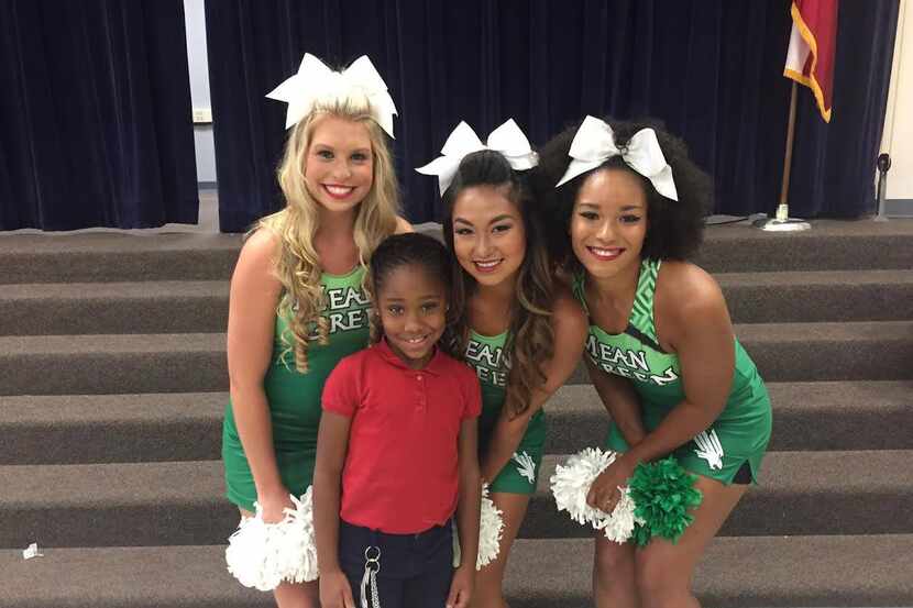 Jordin Phipps, 8, posed with University of North Texas cheerleaders after the school...