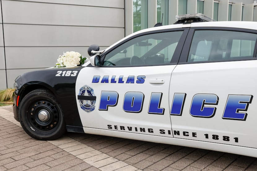 A Dallas police patrol car is set up as a memorial outside of the south central station with...