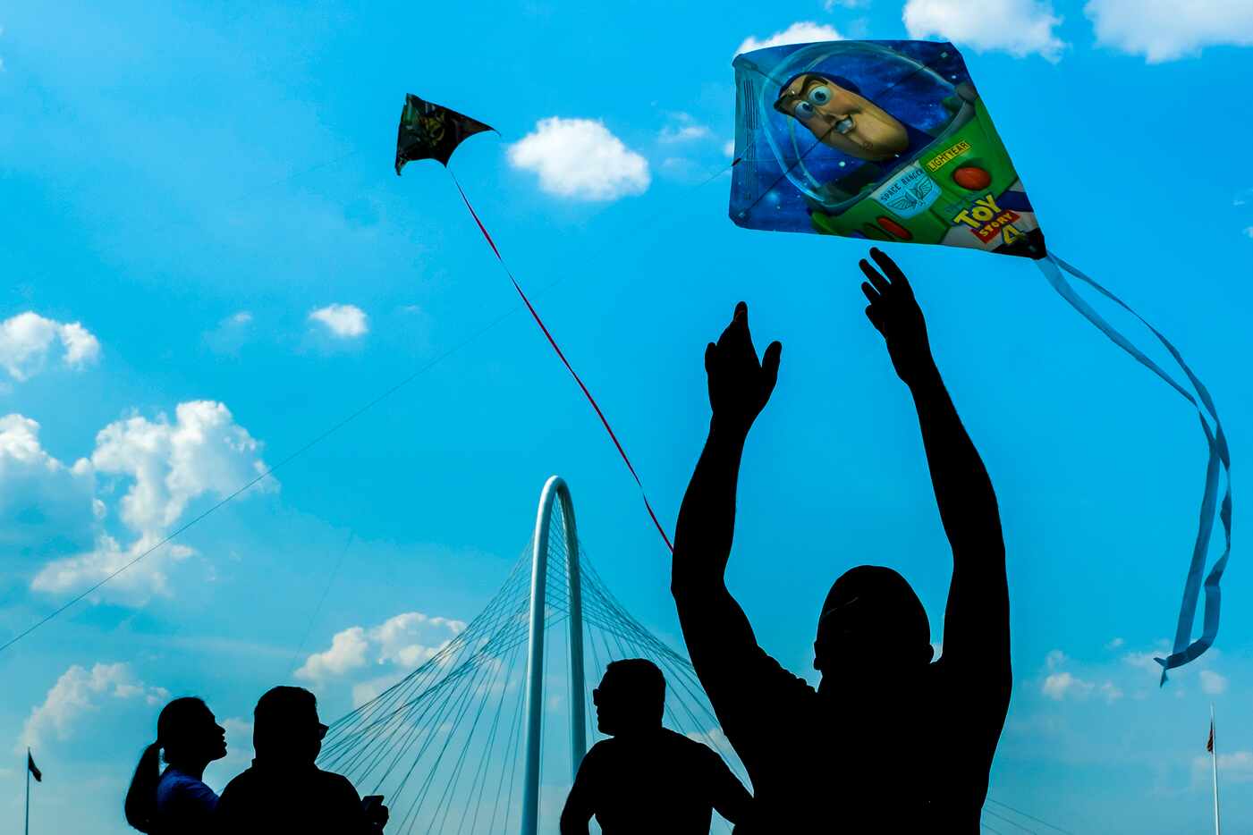People fly kites on the Trinity River floodplains near the Margaret Hunt Hill Bridge during...